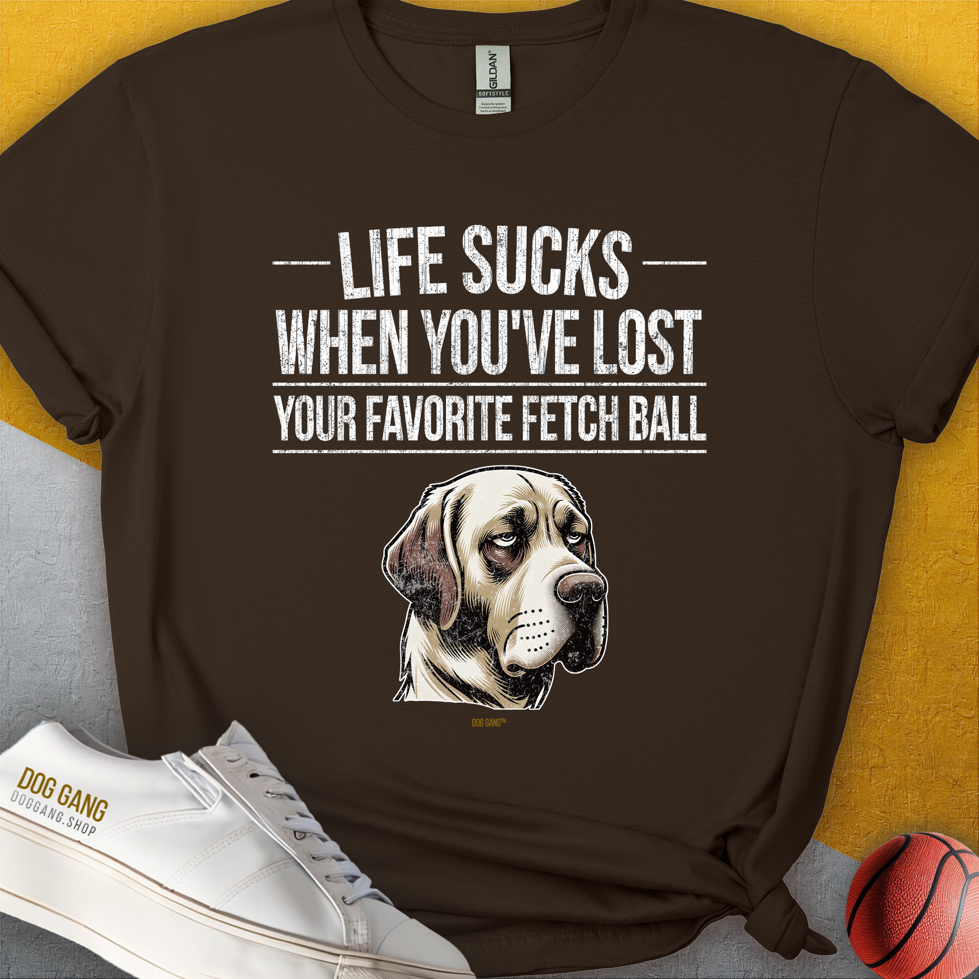 Soft-style cotton blend unisex t-shirt with a sad dog illustration and the quote: Life Sucks When Youve Lost Your Favorite Fetch Ball. Designed by Dog Gang.