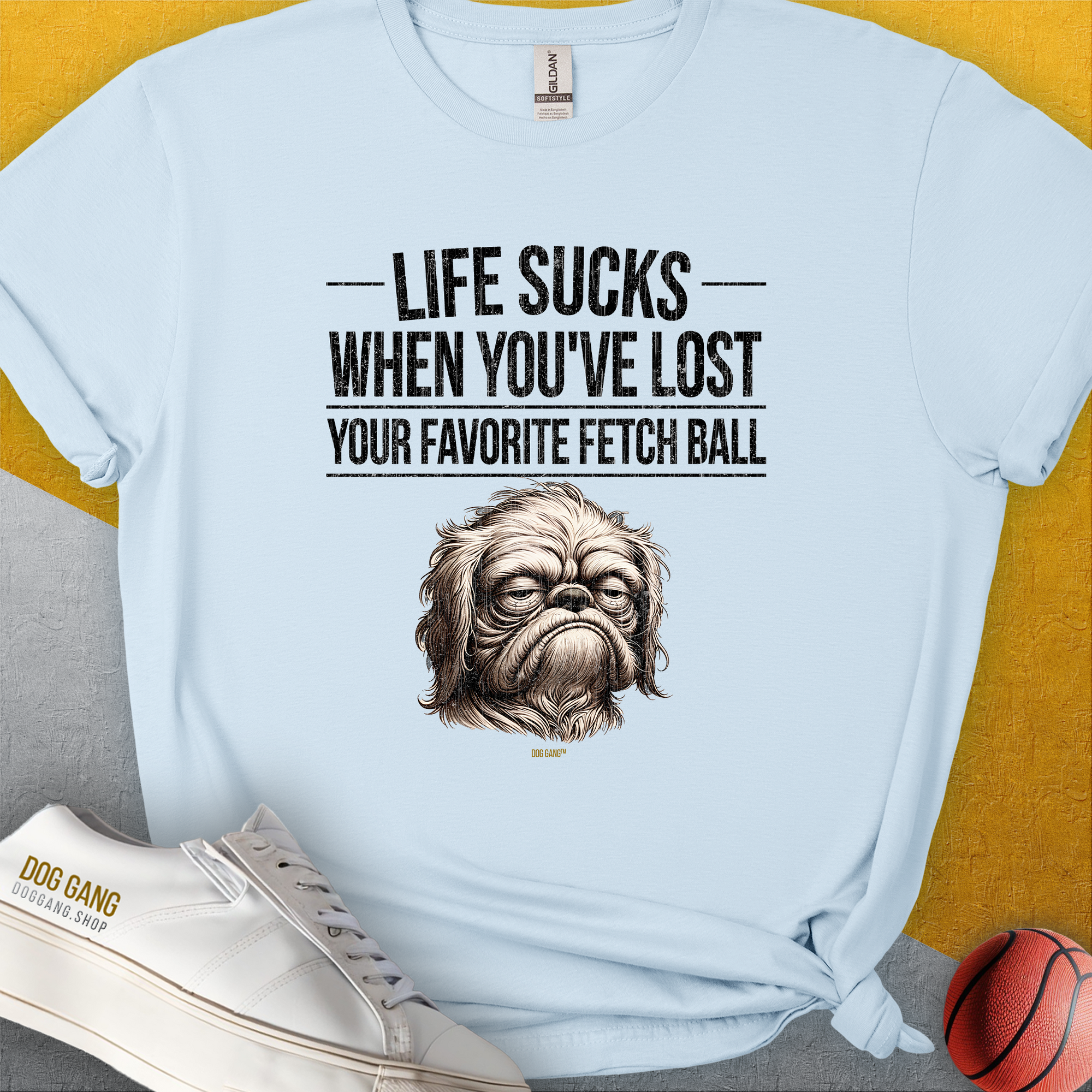 This light blue unisex T-shirt features a sad dog illustration with the quote: Life Sucks When Youve Lost Your Favorite Fetch Ball, Volume 2. Perfect for a dog lover. Designed by Dog Gang.