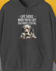 The unisex hoodie features a funny drawn sad dogs face with the quote, Life Sucks When Youve Lost Your Favorite Fetch Ball. Next to the dog is a full glass and a bottle with a label that says: "Chicken Soup with whipped cream, for sad dog days". Perfect for any dog person. Designed by Dog Gang.
