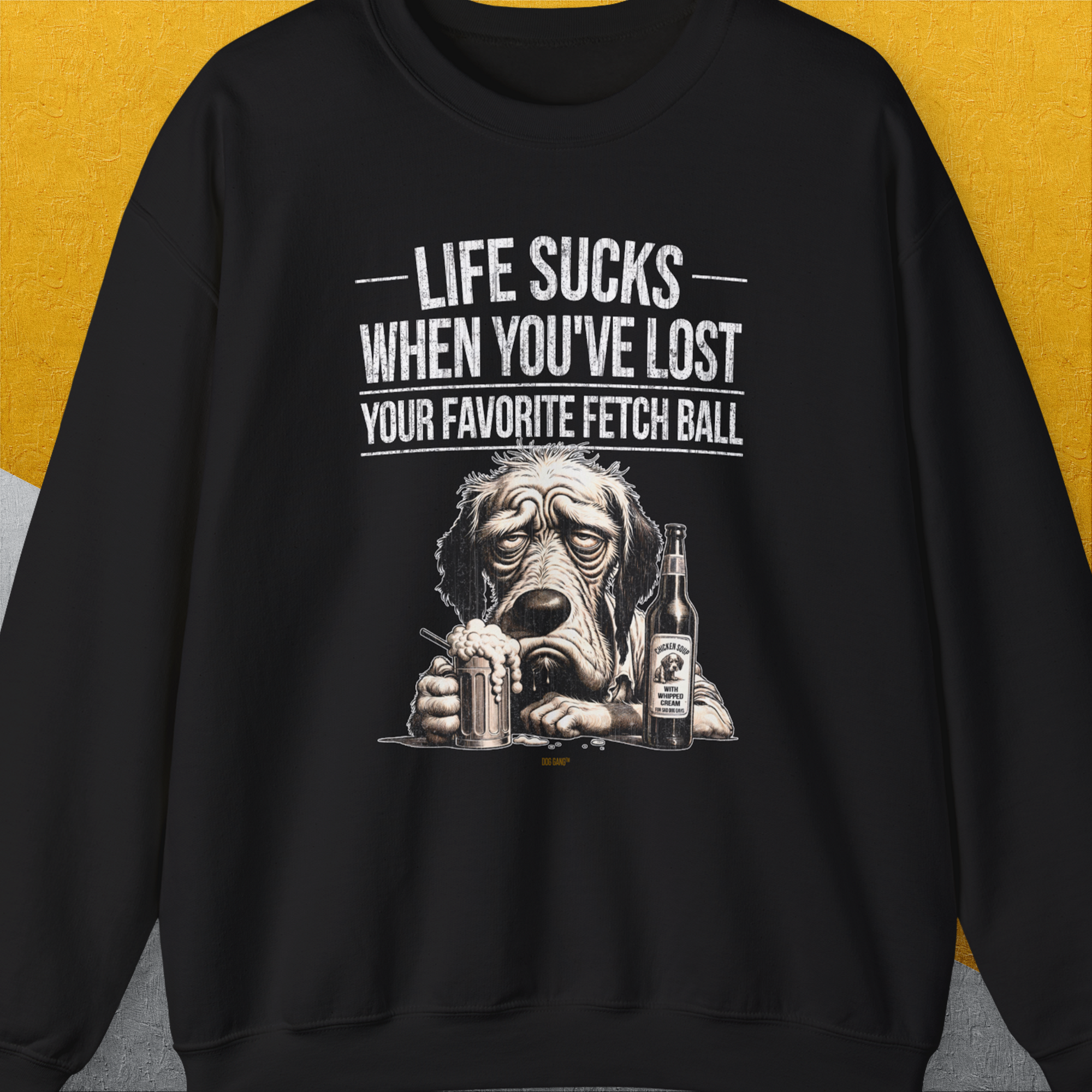 This black shirt showcases a cute dog design with a sad puppy, beer mug /filled with chicken soup for bad dog days), and bottle. It says: Life sucks when youve lost your favorite fetch ball. Funny dog lover gift. Designed by Dog Gang.