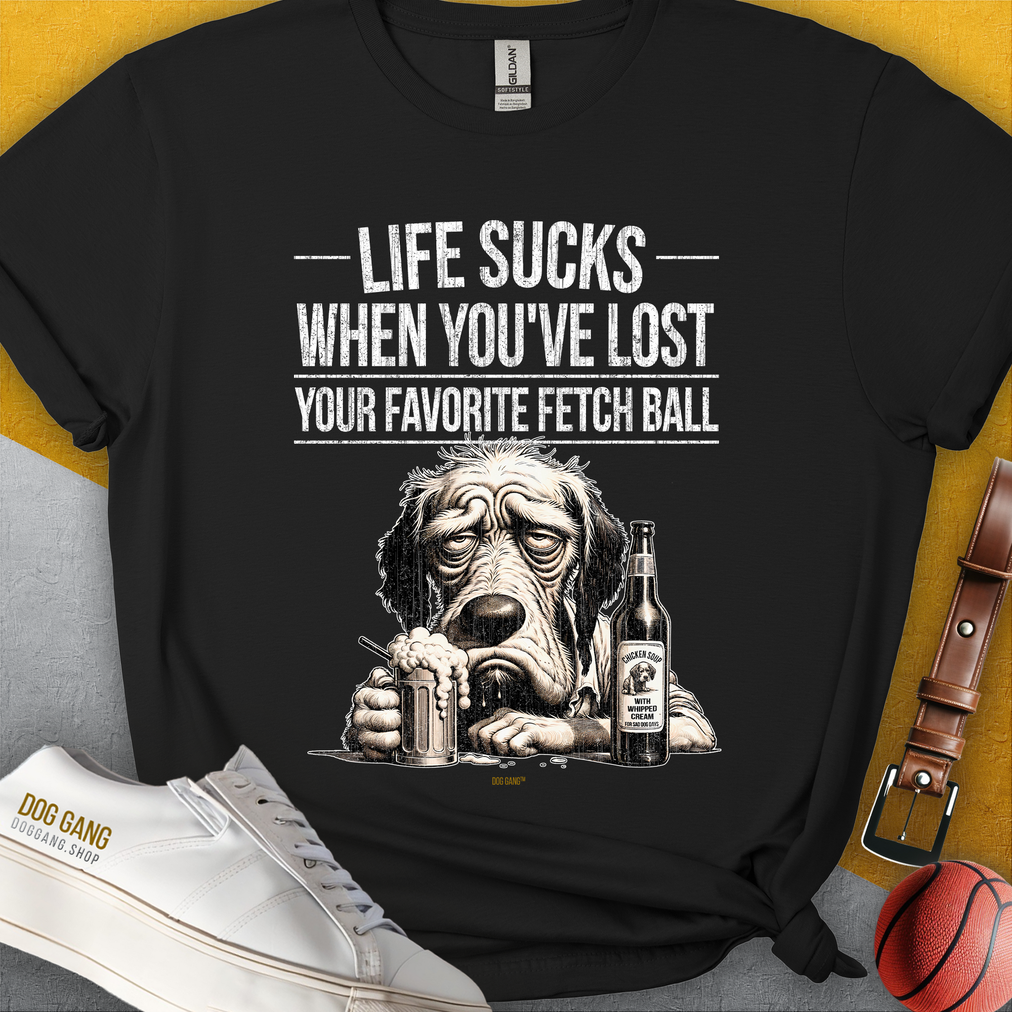 Life Sucks When Youve Lost Your Favorite Fetch Ball, Volume 5 unisex t-shirt. Funny drawing od a depressed dog&#39;s face. Next to the dog is a full glass and a bottle with a label that says: &quot;Chicken Soup with whipped cream, for sad dog days&quot;. Designed by Dog Gang.