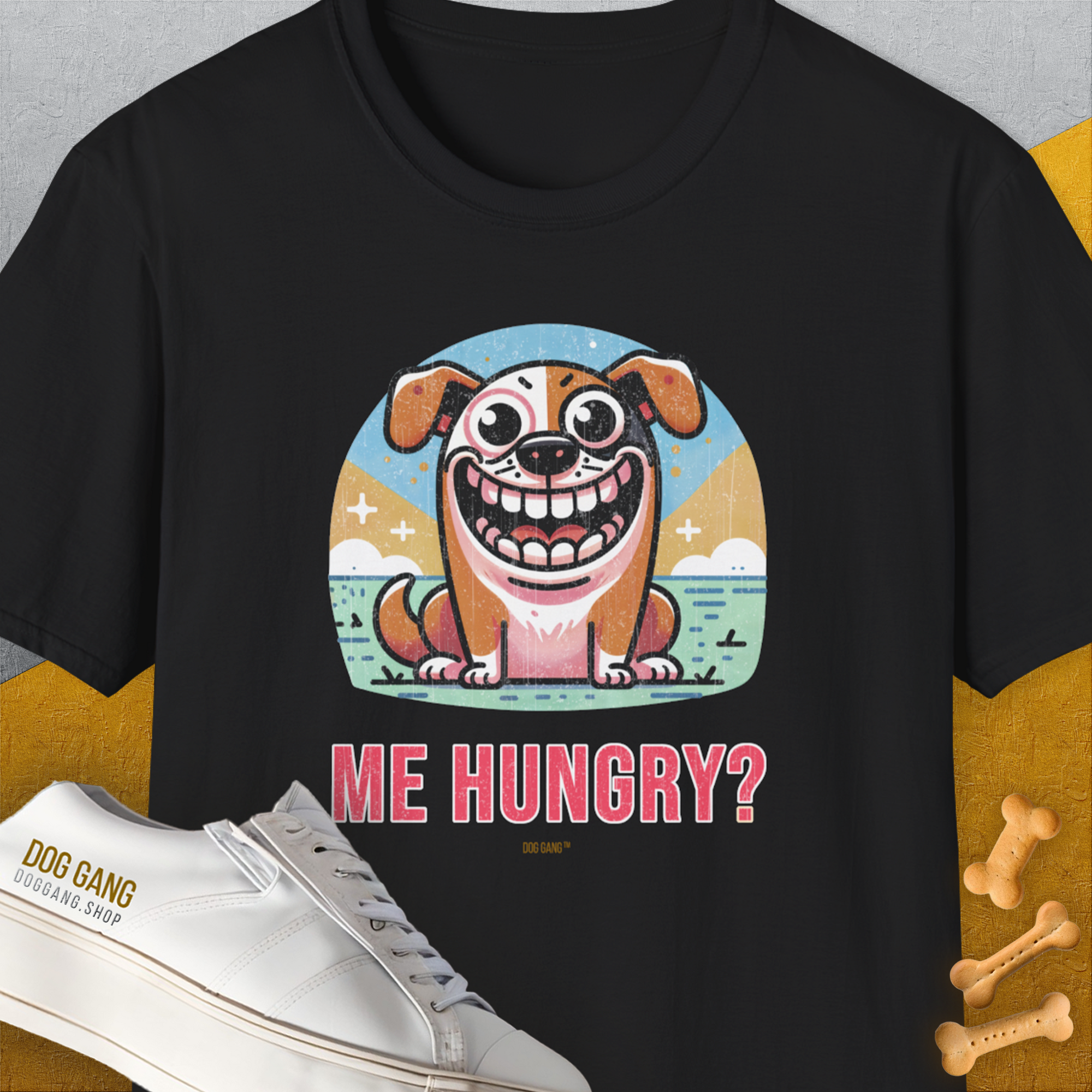 The Me Hungry? Volume 3, Unisex T-Shirt in black features a cute cartoon dog with the phrase ME HUNGRY? next to bone-shaped cookies. Perfect for the dog lover with a sense of humor. Designed by Dog Gang.