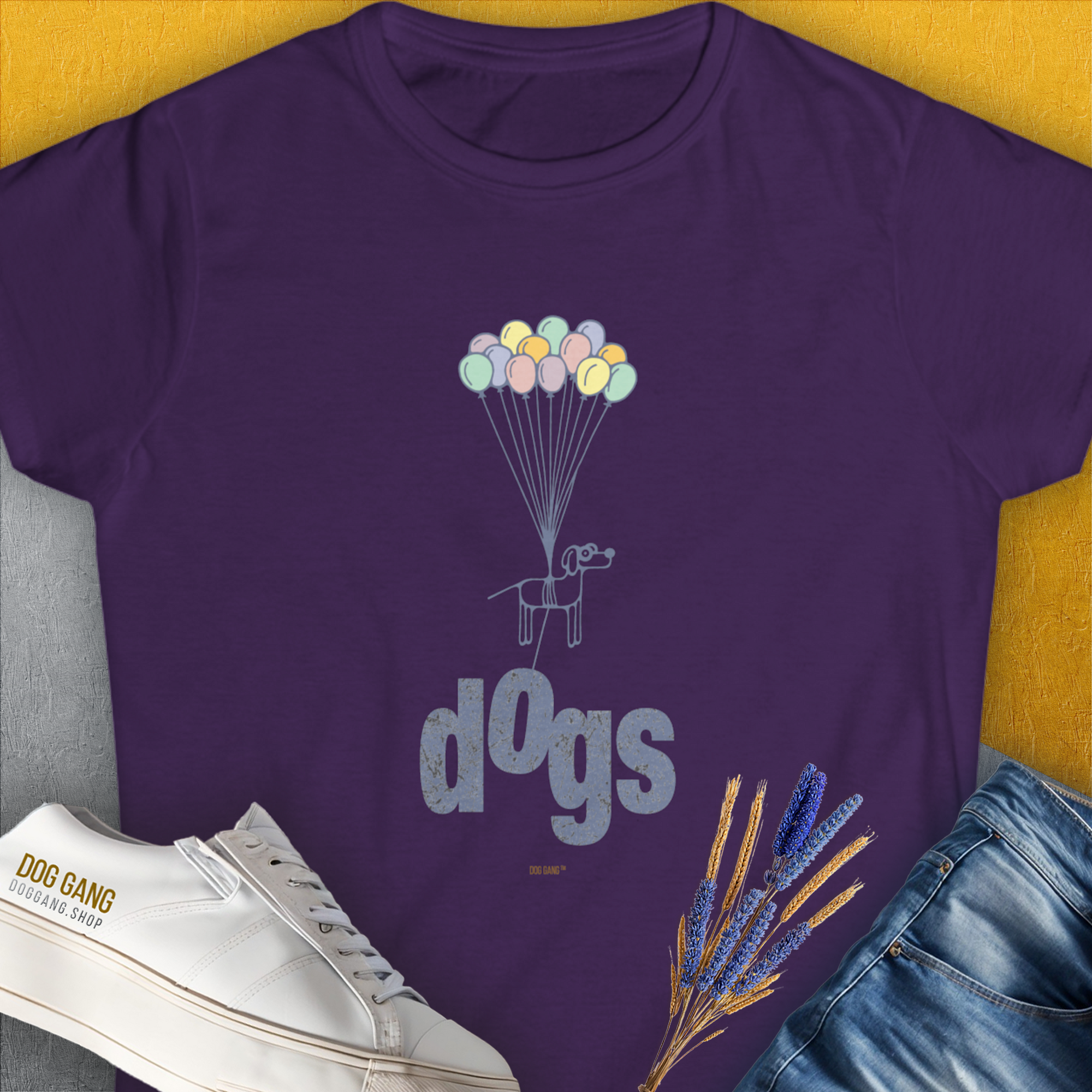 Purple tee with a fun dog and balloons design, featuring white shoes and DOG GANG text. Perfect for a dog lover. Designed by Dog Gang.