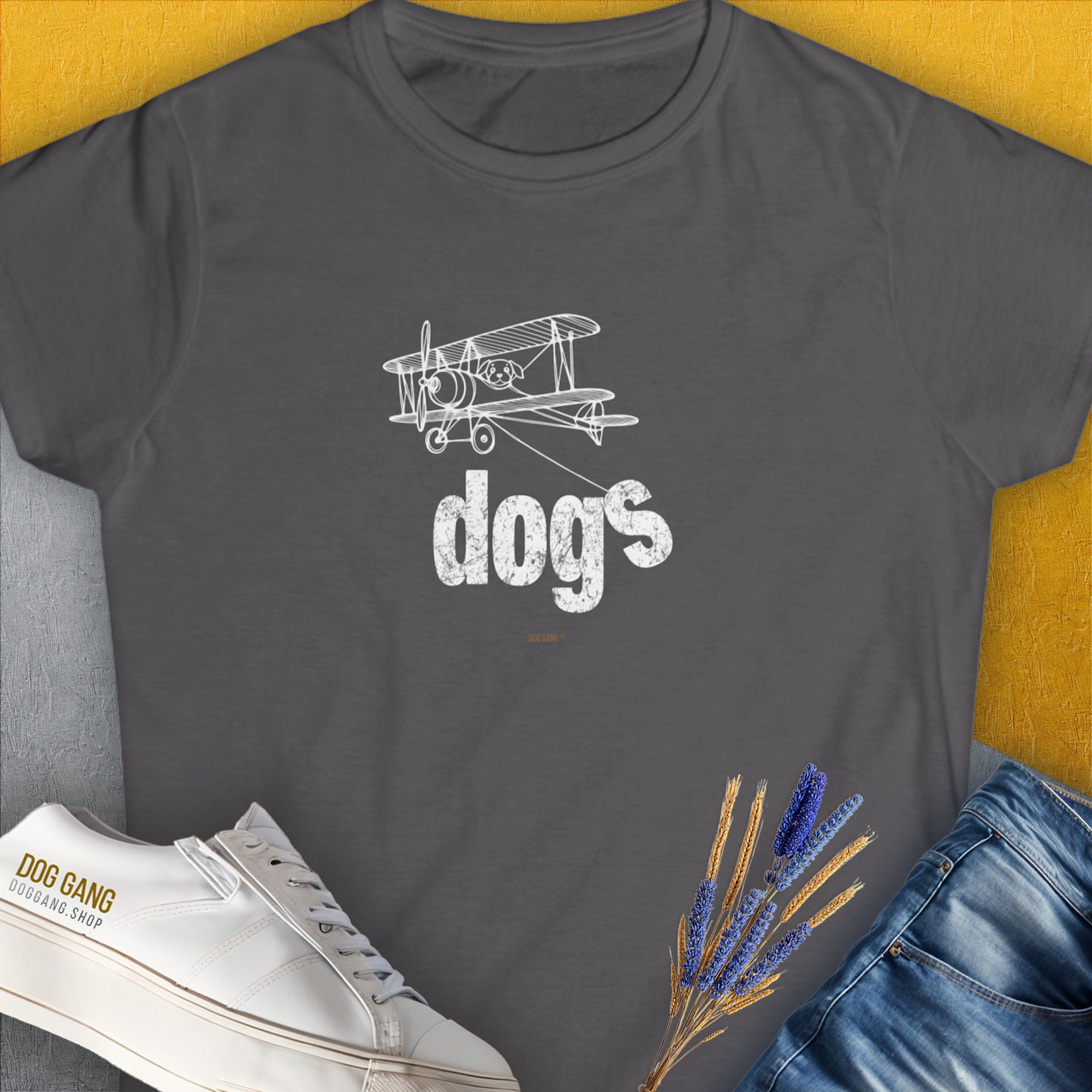 Dog-themed tee featuring dogs and a vintage plane in yellow. Perfect for any dog lover. Designed by Dog Gang.