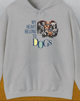 This funny dog shirt displays a heart-shaped collage of adorable dog faces with the quote My Heart Belongs to Dogs. Designed by Dog Gang.