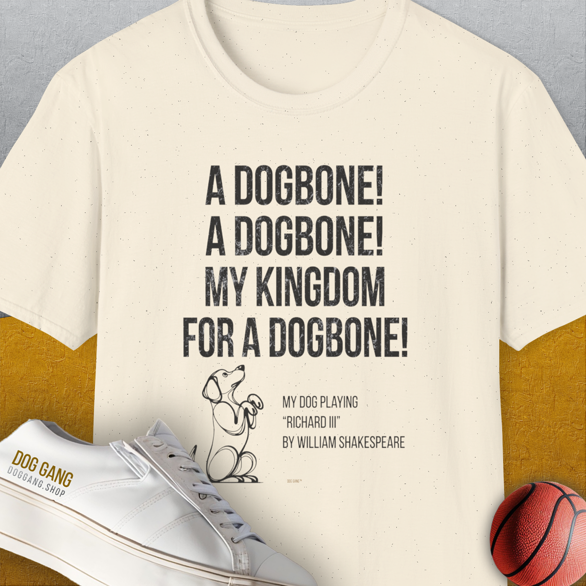 The My Kingdom For A Dogbone Unisex T-Shirt in natural color features a funny Shakespeare parody quote and playful dog illustration on 100% cotton, soft-style fabric. Designed by Dog Gang.