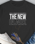 The Ultimate New Black T-Shirt features a funny dog-themed quote in white: Artfully arranged dog hair on shirts is the new black. Designed by Dog Gang.