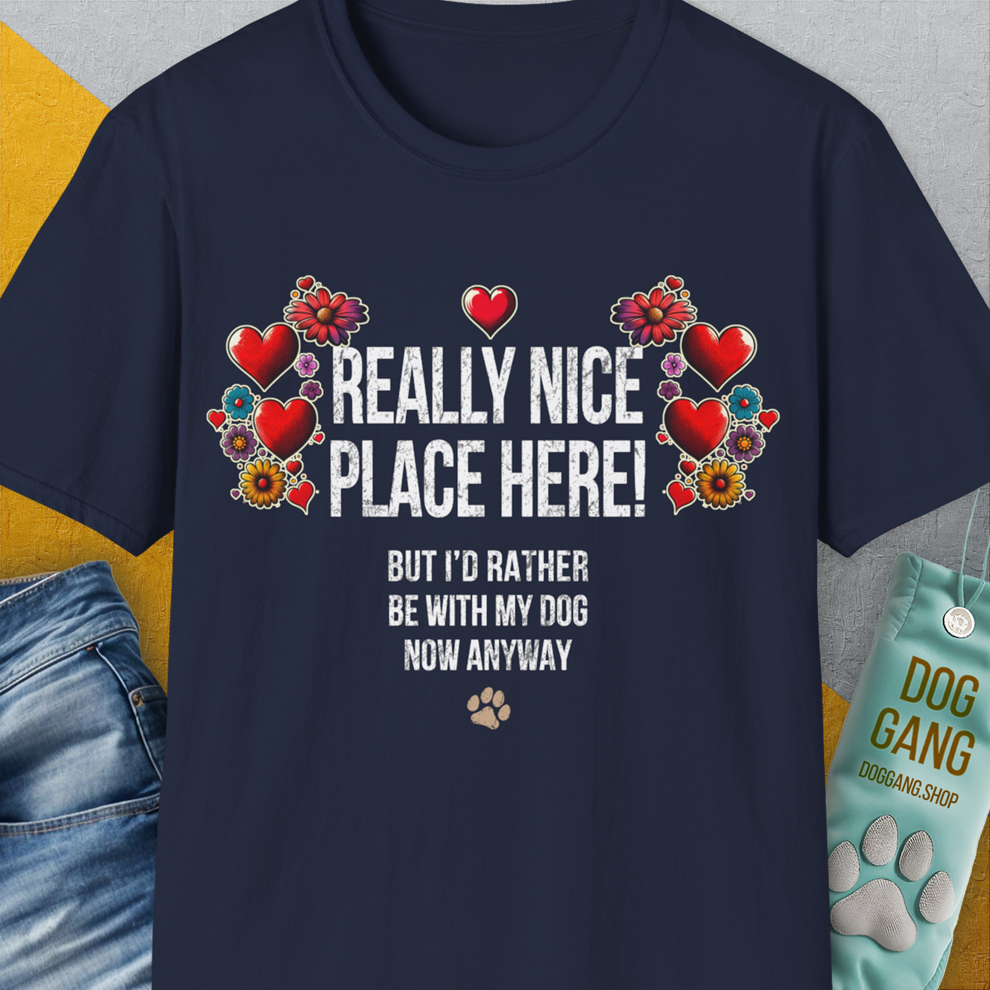 This navy unisex t-shirt features a floral and heart design with the funny quote: Really nice place here! But Id rather be with my dog now. Designed by Dog Gang.
