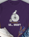 So... Woof? Volume 3 Womens T-Shirt features a playful dog on an old bicycle with Dogs do dog things. So... Woof? text. A perfect funny dog shirt for any dog lover. Designed by Dog Gang.