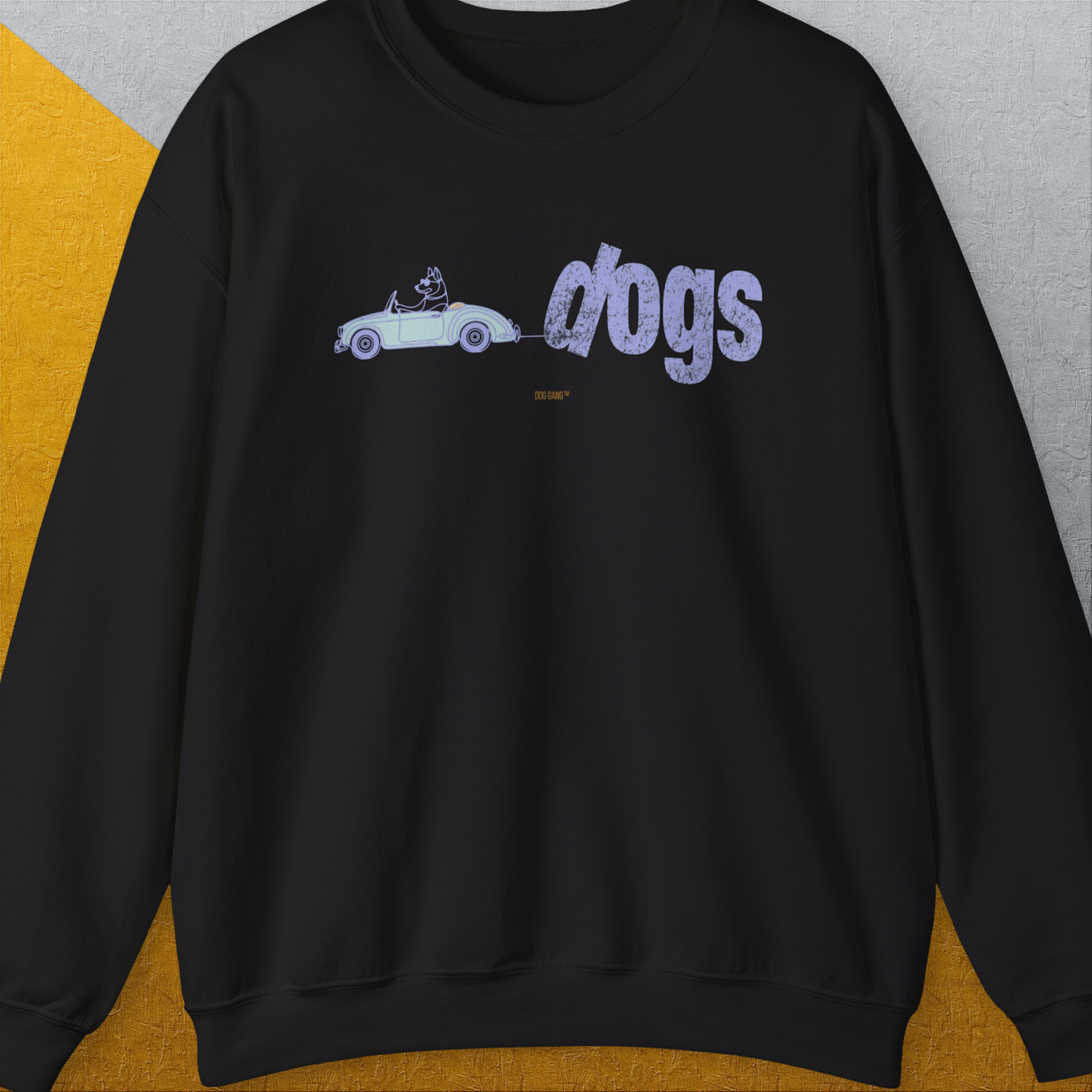The Dog Gang Minimalistic Series II, Volume 2 features a black unisex sweatshirt with a car-riding dog graphic and dogs text. Designed by Dog Gang.