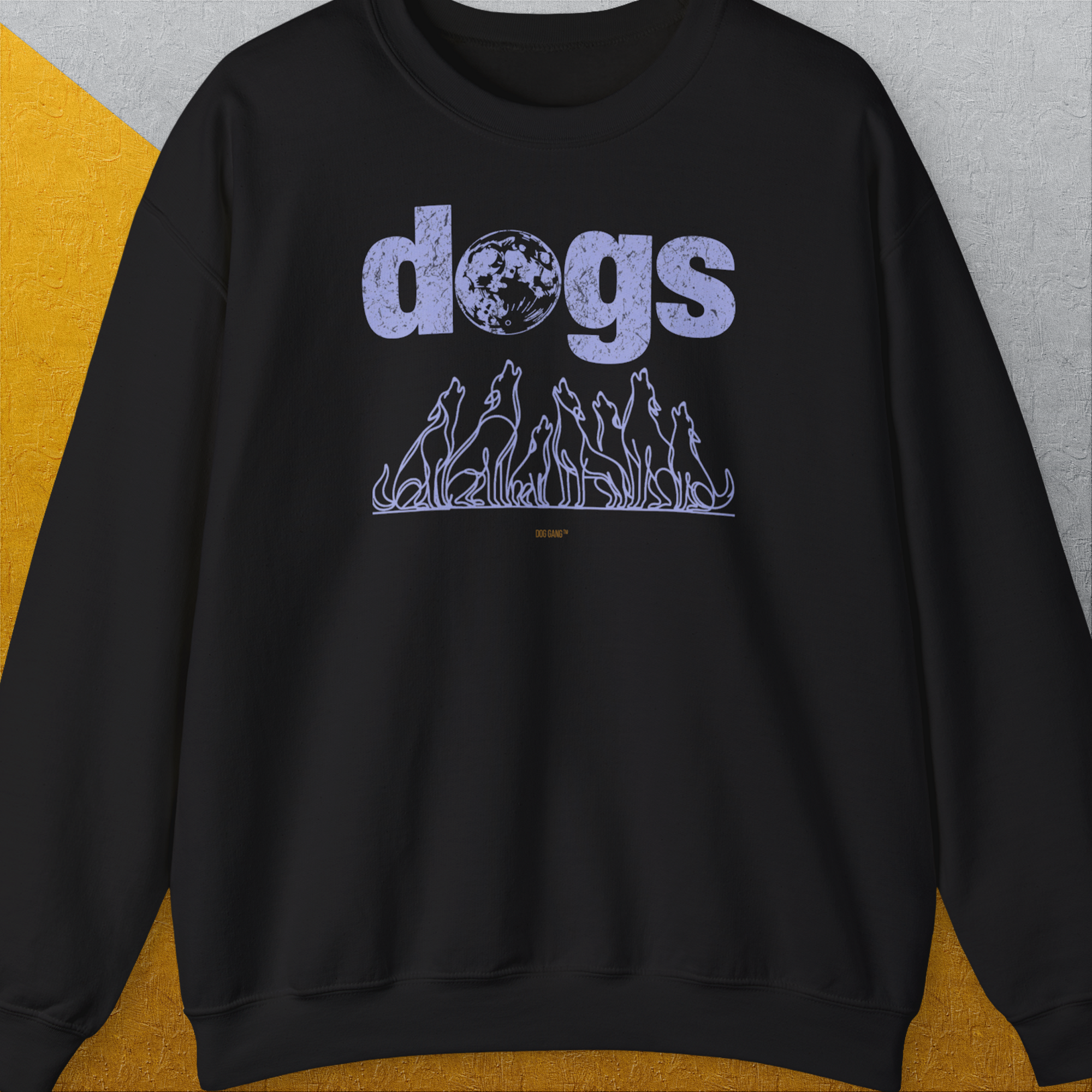 Bold purple dogs text with howling dog silhouettes under a moon on black fabric highlights this funny dog shirt. Crafted from a soft cotton-polyester blend. Designed by Dog Gang.