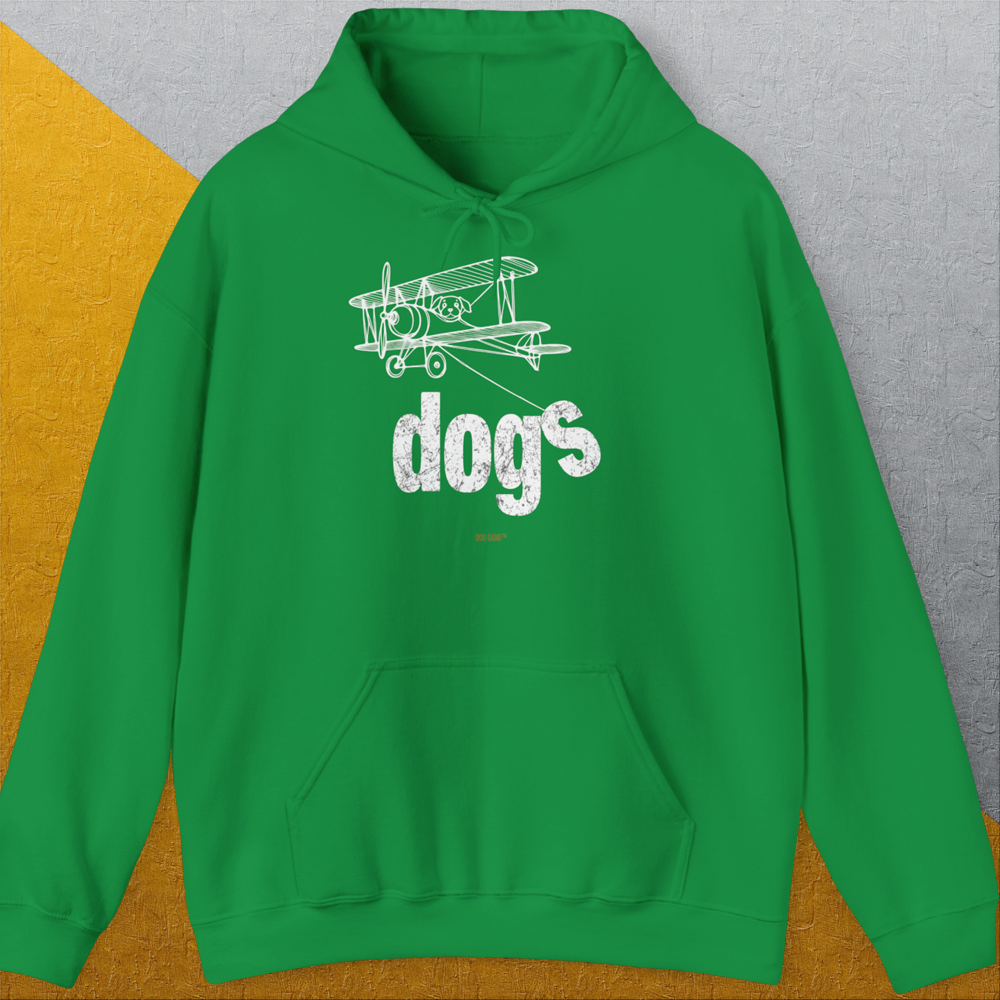 The Dog Gang Minimalistic Series II, Volume 4 unisex hoodie in Irish green features a white biplane sketch and the word dogs. Cute dog design for every day. Designed by Dog Gang.