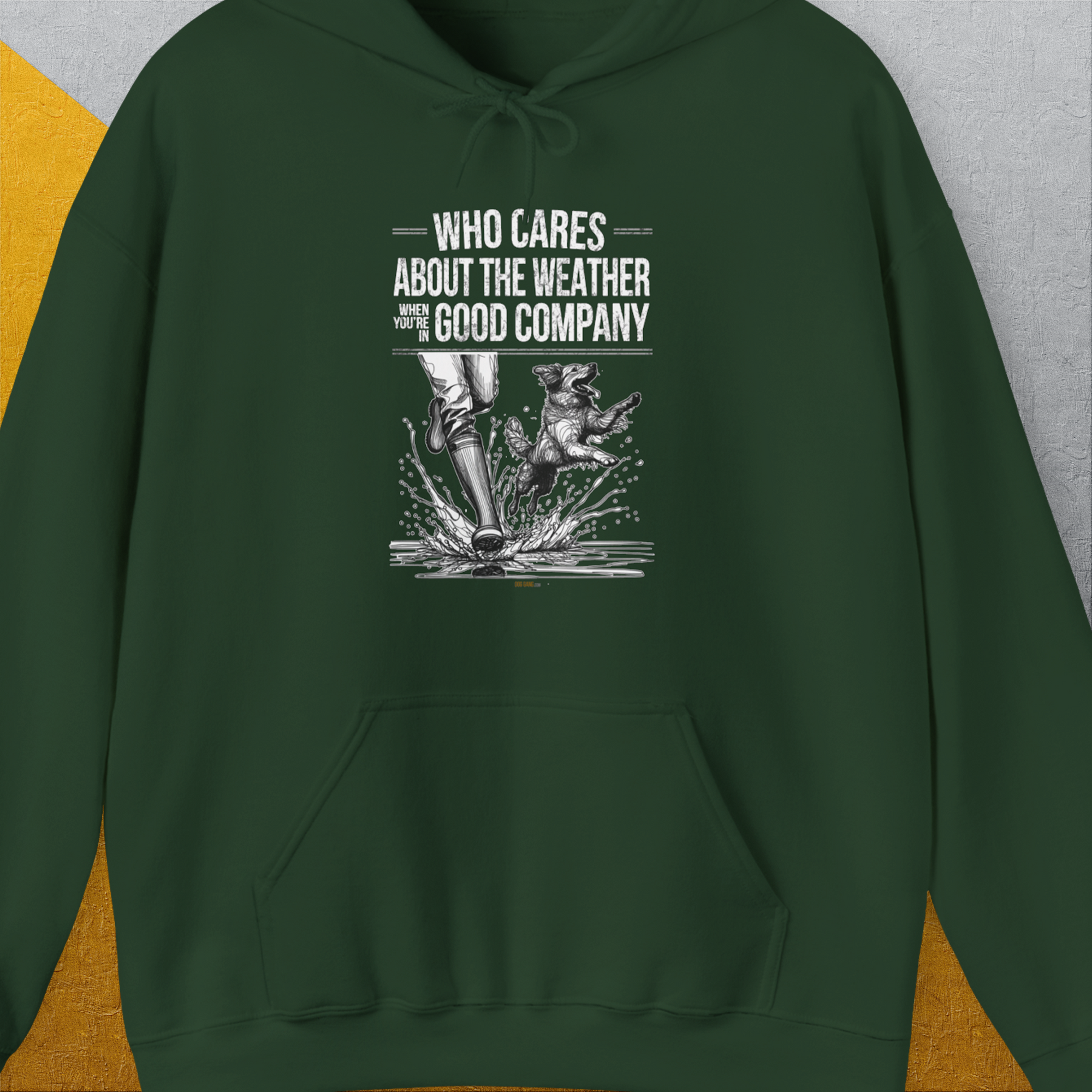 Forest green hoodie with a cute dog design: person and dog in the rain with Who Cares About The Weather When Youre In Good Company text. Perfect for any dog lover. Designed by Dog Gang.