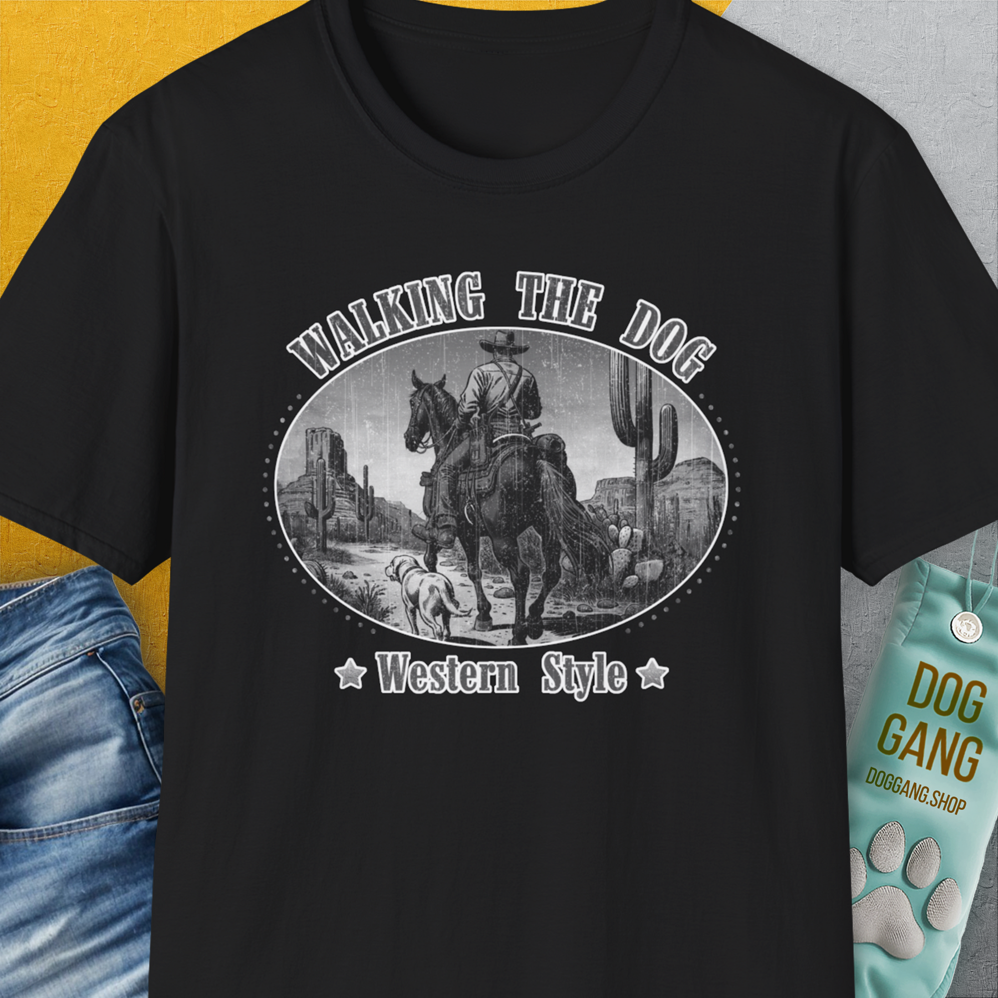 The Walking The Dog, Western Style, Volume 3 unisex T-shirt in black is crafted from soft-style cotton with a funny dog design of a cowboy and his dog. Designed by Dog Gang.