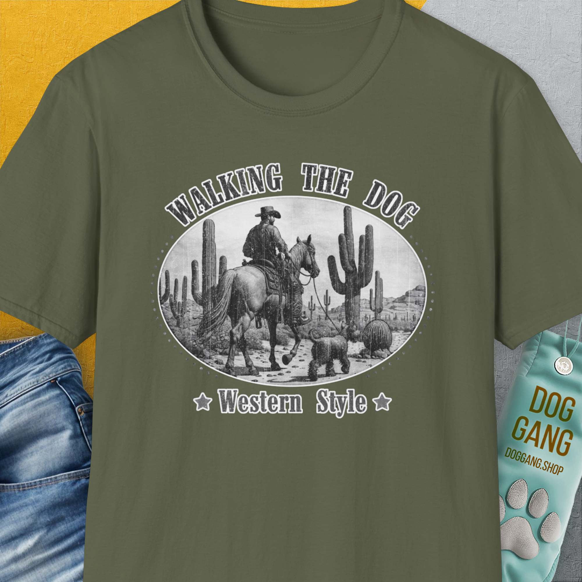 Military green shirt with a cowboy and hat graphic, called Walking The Dog, Western Style, Volume 1. Designed by Dog Gang. Perfect for the dog lover who enjoys a comical twist!.